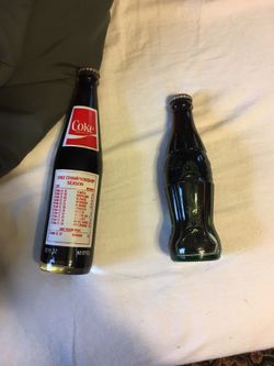 2 vintage coke bottles filled