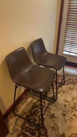 2 brown leather high top chairs