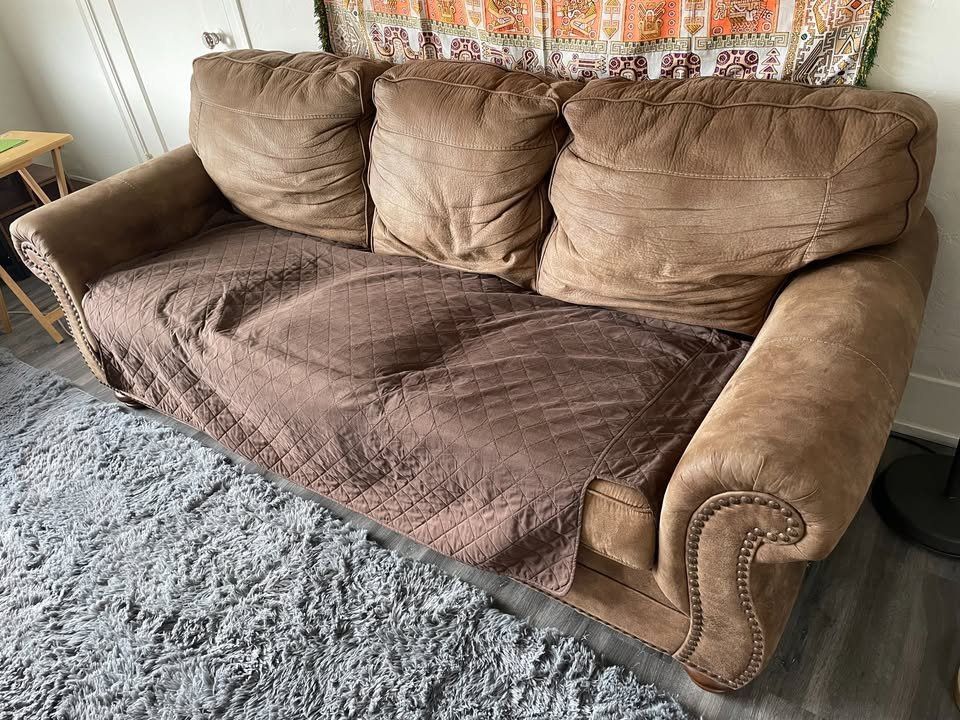 Comfy brown sofa with cover