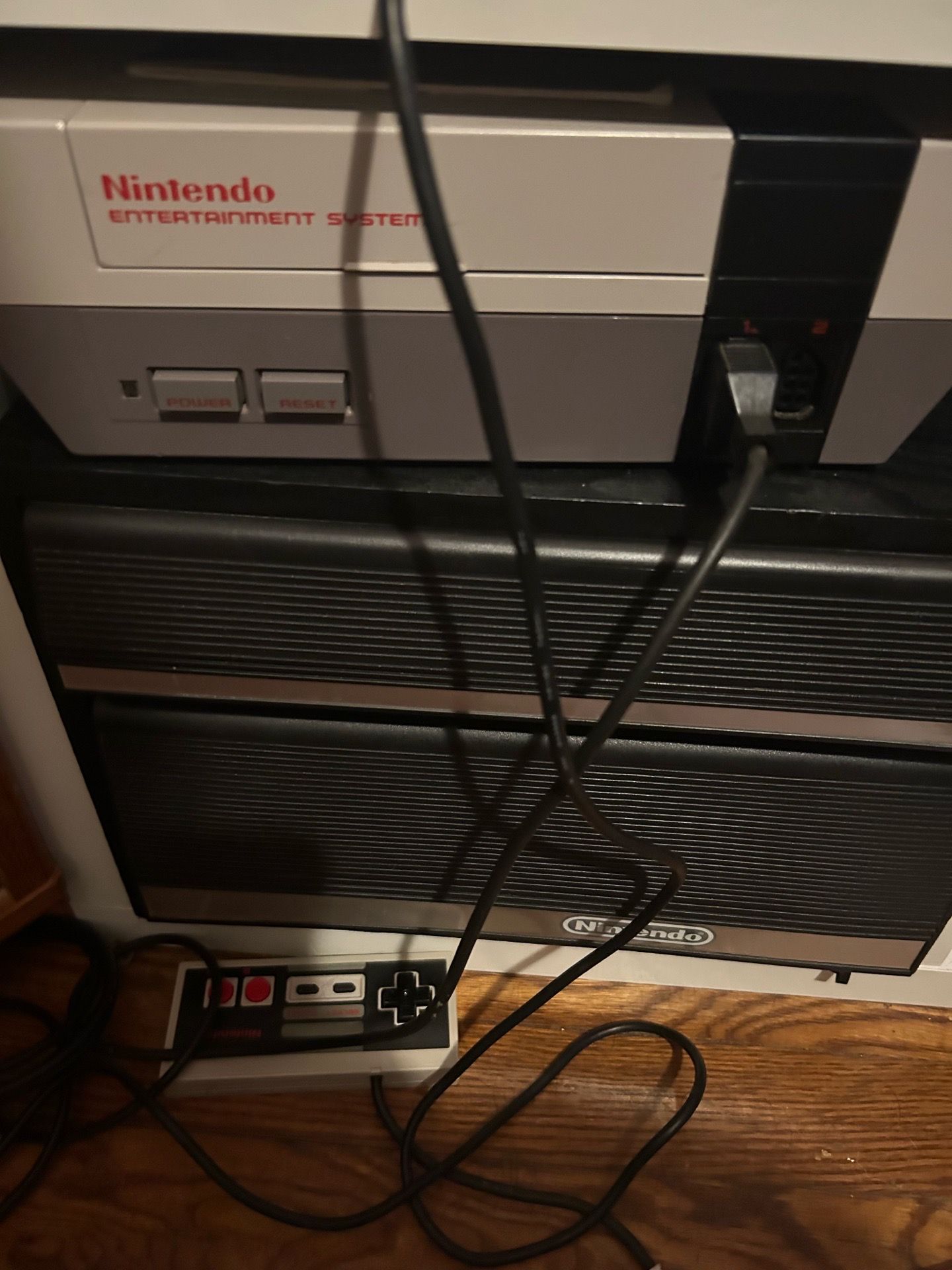 NES with 2 controllers, gun, and cabinet
