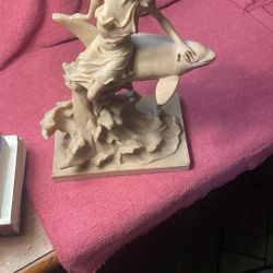 Lady Seating On A Dolphin Statue 