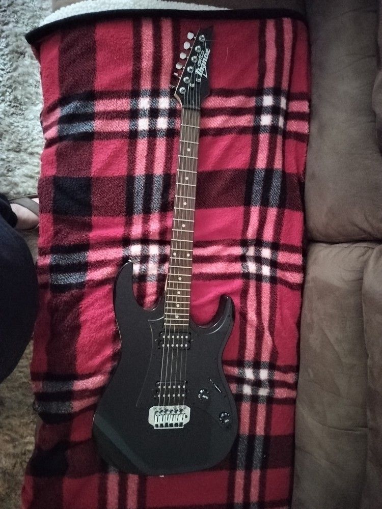 Ibanez Pearl Black Guitar/Husqvarna Chainsaw