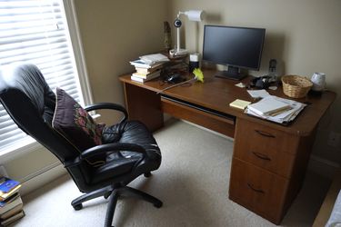 Two wooden desks (one medium and one small), one desk lamp