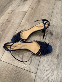 Jewel Badgley Mischka navy blue strappy sandals featuring crystal embellishments and a kitten heel.