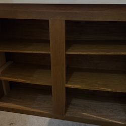 This appears to be a freestanding wood base storage cabinet with a laminate countertop, likely used in a utility area like a laundry room, garage, or 