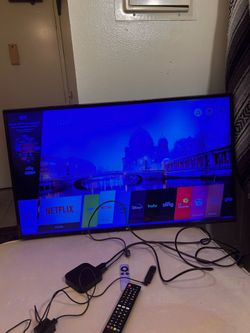 LG 42" Smart TV including Plug, Remote, Apple TV, and Roku