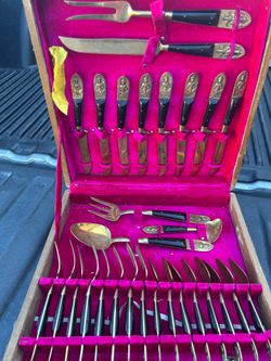 This is a vintage Siam Bangkok Thailand flatware set, likely bronze or brass with dark wood handles,wooden storage