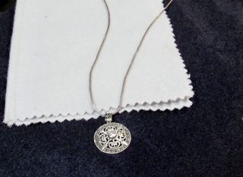 Sterling Silver Necklace and Pendant with Stones. 925, Sterling. About 18 inches in length and the pendant is almost 1 inch in diameter.