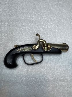 vintage Japanese novelty pistol lighter styled after an 18th-century flintlock/percussion derringer pocket pistol.