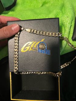 GLD gold chain and pacer emblem
