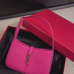 Bright pink, smooth leather crossbody bag with golden logo, luxurious style, women's retro type shoulder bag at the armpit