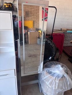 freestanding jewelry armoire with a full-length mirror.