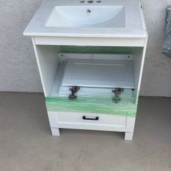 white single-sink bathroom vanity with a ceramic top and a single drawer.  
