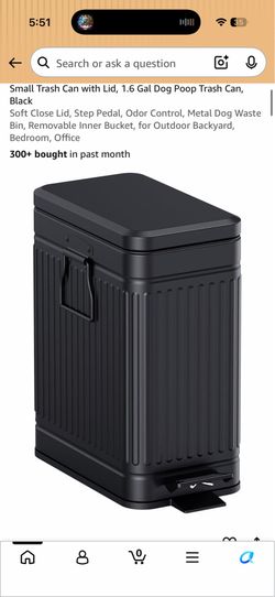 Black dented small trash can
