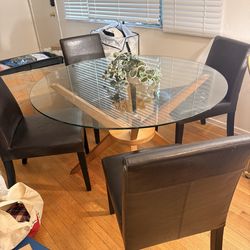 Dining Table- glass top - solid wood base -4 Dark wood and leather chairs
