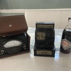 Antique  Electrical Meter Reader, a Coin Machine and a bottle of coke