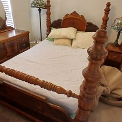 antique wooden four-poster bed with a carved headboard and turned posts
