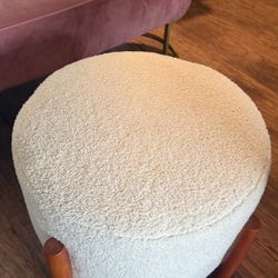 Modern round bouclé ottoman in excellent condition. 