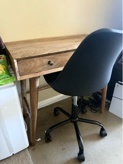 Wooden desk and black chair
