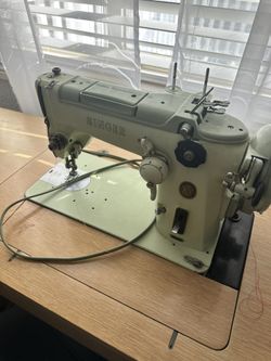 Sewing Machine With Discs And Manual