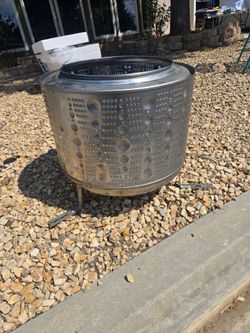 Stainless steel fire pit with legs $100 I can include a delivery for $20 and two bundles of wood for an additional $20