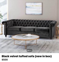 Black velvet tufted sofa