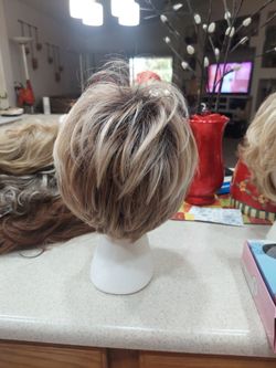 7 new wigs in various colors and styles.   1 used wig, red and curly with headband
