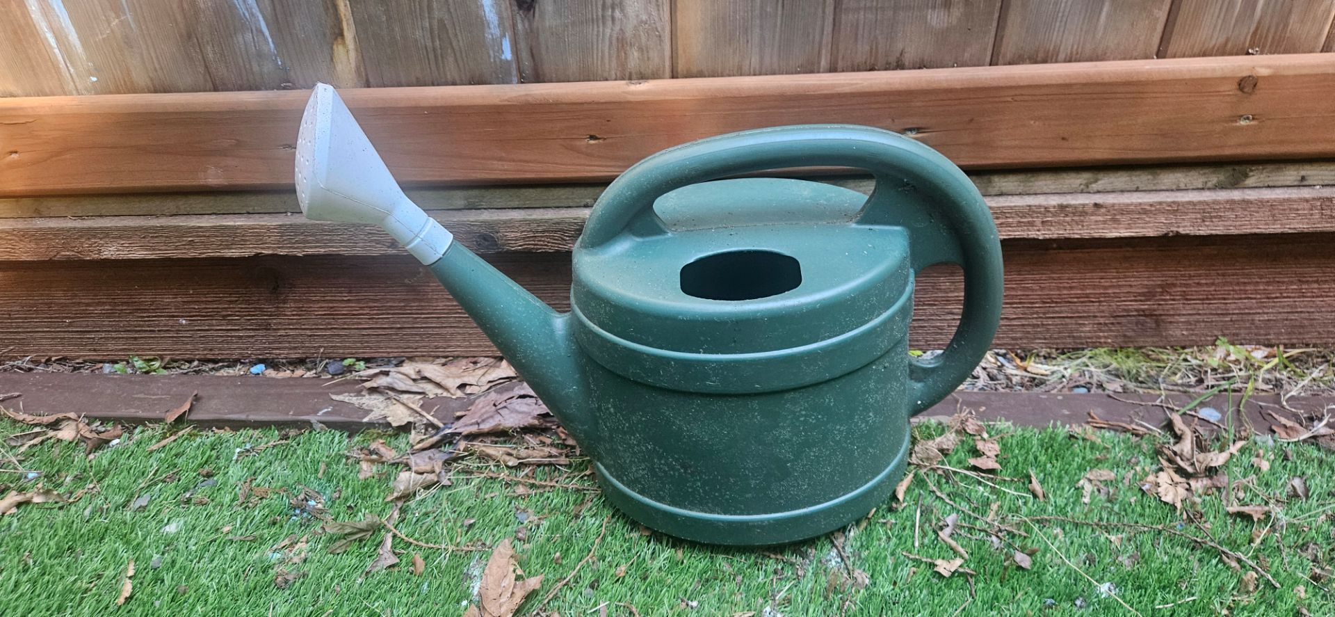 Green plastic watering can