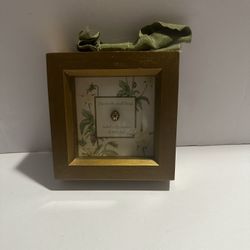 Gold-framed decorative box featuring a small Lady Bug And  text