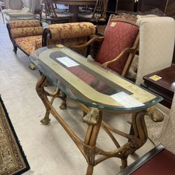 glass-top console table with a bamboo or rattan base and ornate gold-colored accents - 47”x 17” 