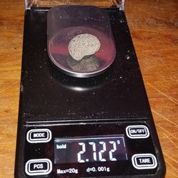Small Meteorite Magnetic And Weighs. 2.722 In A Scale