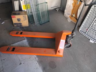 Pallet jack and folding tables plus stainless steel kitchen prep tables of different sizes