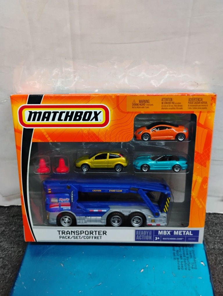 2006 Matchbox Transporter Pack, an MBX Metal set featuring a large transporter vehicle and several smaller die-cast cars. Rare