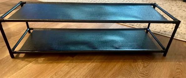 Simple black 2-tier shoe rack in good condition.