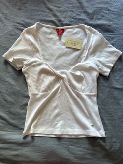 white GUESS ribbed twist-front top with a sweetheart neckline.