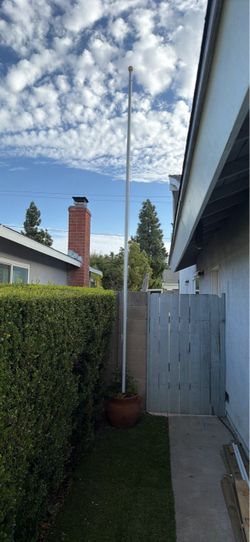 Flag pole with weighted base pot