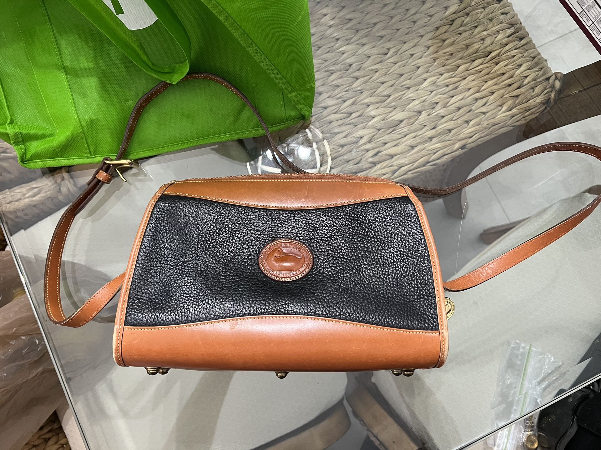 black & tan pebble‑grain Dooney & Bourke crossbody bag