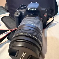 Cannon EOS Rebel T5 DSLR camera with lenses and carrying case.