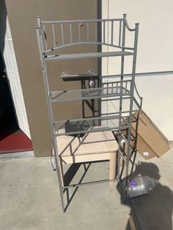 Bathroom shelving unit. Small table. Toaster.