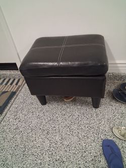 Black faux leather ottoman