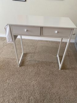 Small desk and plastic chairs