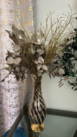 Golden vase with golden flowers