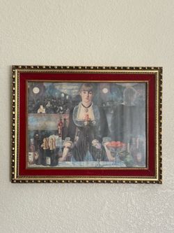 Framed print reproduction of Edouard Manet's famous 1882 painting, "A Bar at the Folies-Bergère