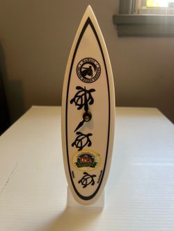 White surfboard-shaped clock with Dole Plantation logo and "Honu" sea turtle graphics. New 10”
