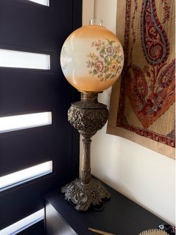 Beautiful vintage Victorian style parlor lamp with a hand painted floral glass globe and ornate decorative metal base