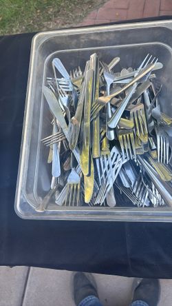 Approximately 100 pieces of knives and forks