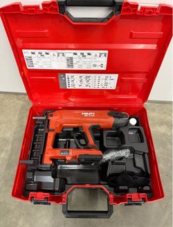 Hilti BX 3-22 battery-powered actuated nailer stored in its original red hard case with molded inserts. Includes the tool and accessories in fitted co