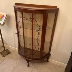 vintage walnut bowfront display cabinet featuring curved glass doors with delicate floral etching
