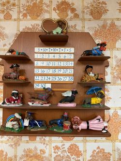 Danbury Mint Dachshund Perpetual Calendar set featuring 12 themed dog figurines.