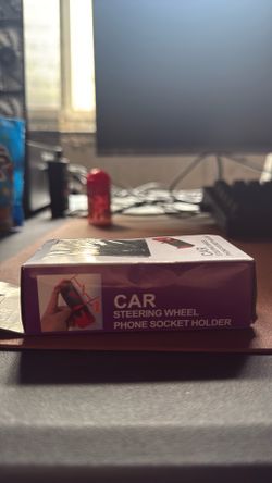 Steering wheel phone holder